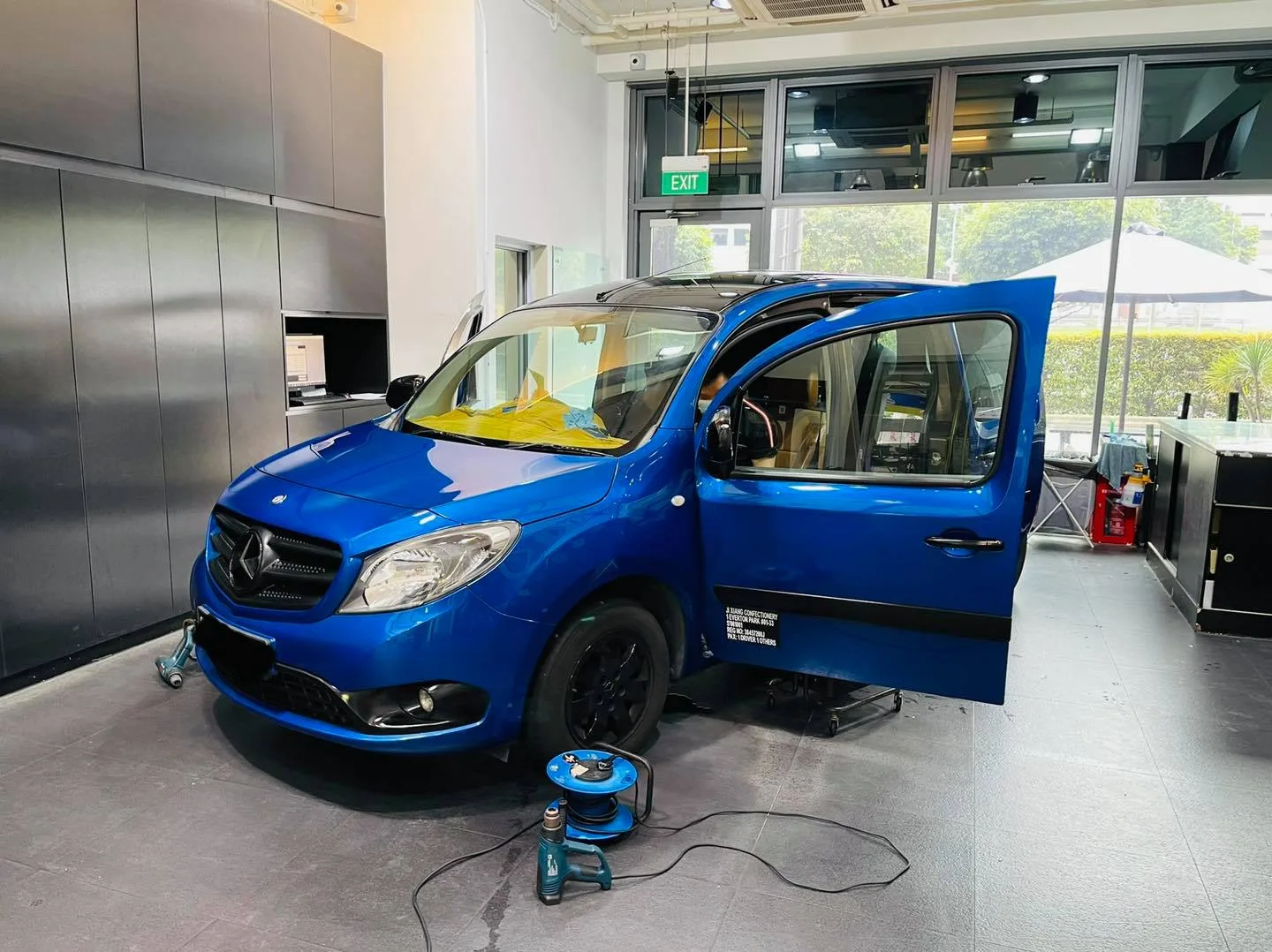 Blue Mercedes-Benz van front three-quarter during tinting at Infratint Singapore