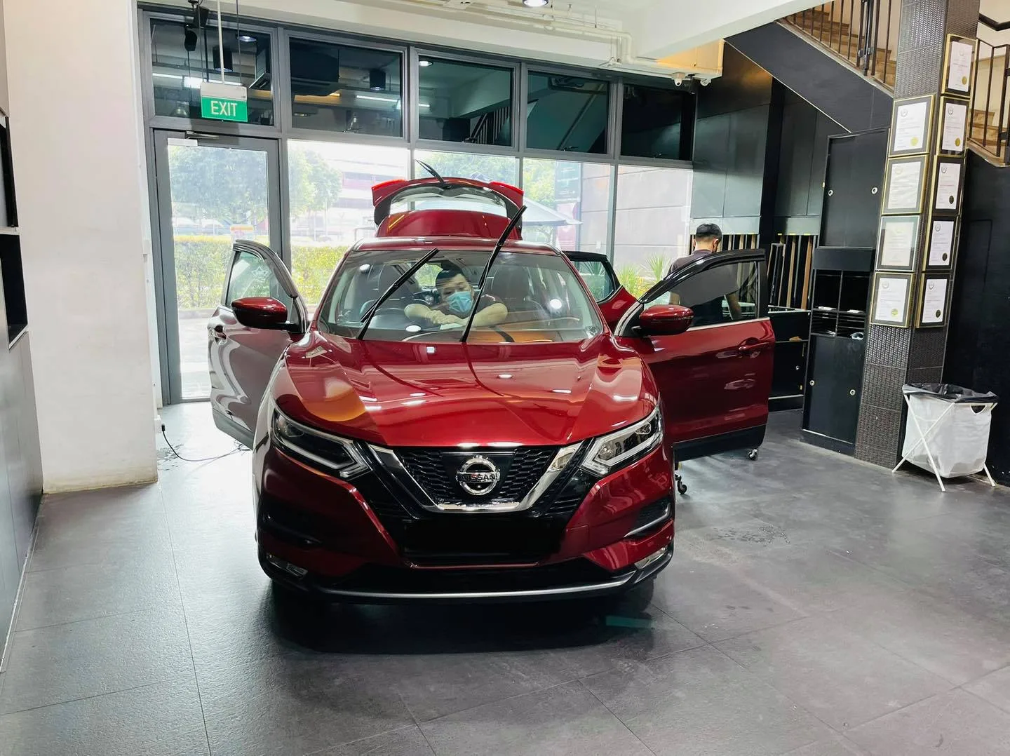 Red Nissan Qashqai with doors and tailgate open at Infratint Singapore for window tinting