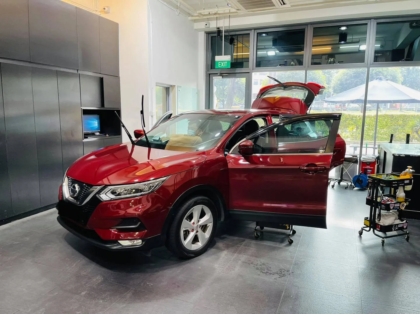 Red Nissan Qashqai front three-quarter during window tinting at Infratint Singapore