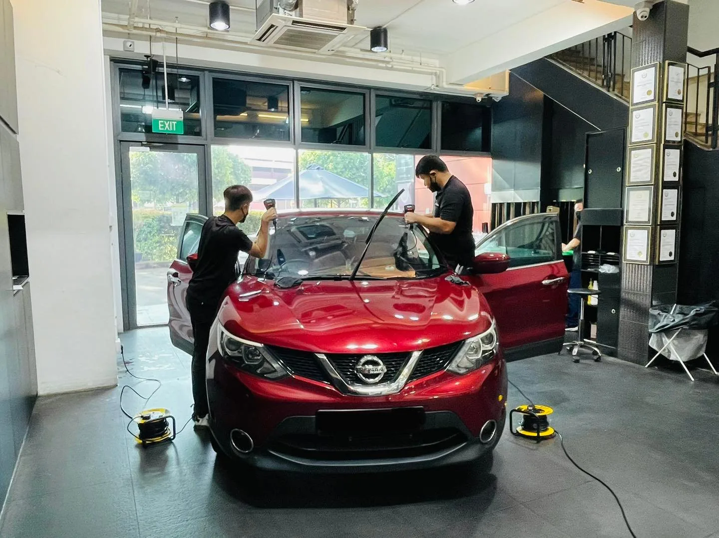Red Nissan Qashqai having windscreen film fitted at Infratint Singapore