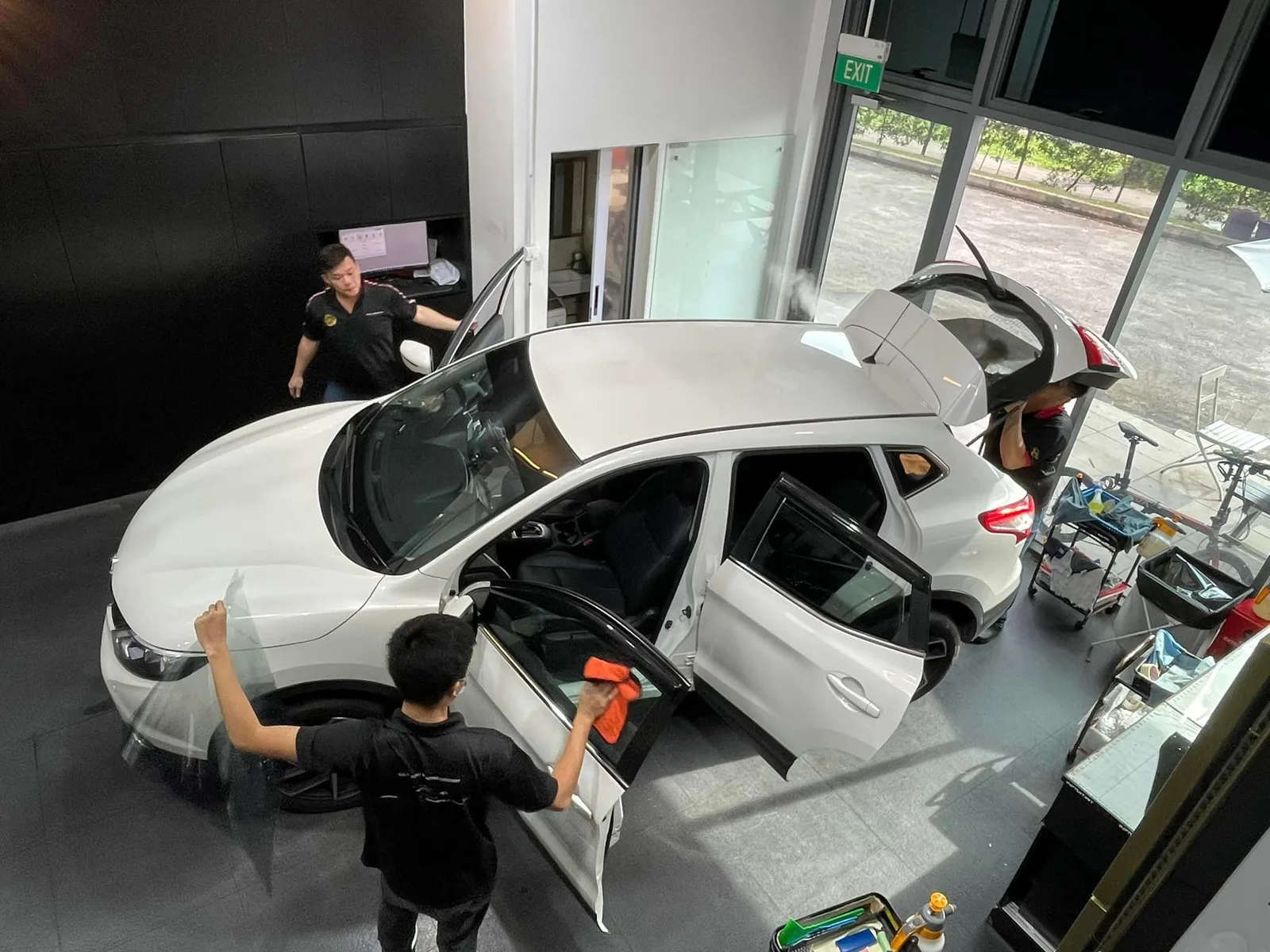 Overhead view of white Nissan Qashqai window tinting at Infratint Singapore