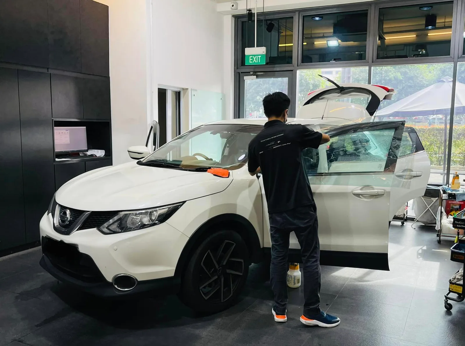 White Nissan Qashqai with tailgate open during window tinting at Infratint Singapore