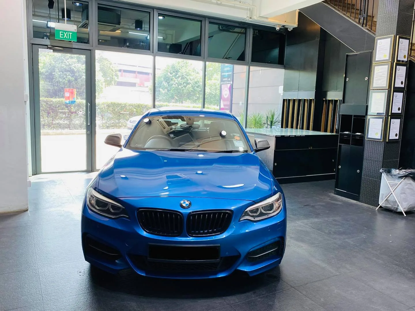 Blue BMW 2 Series coupe inside the Infratint Singapore showroom for window film
