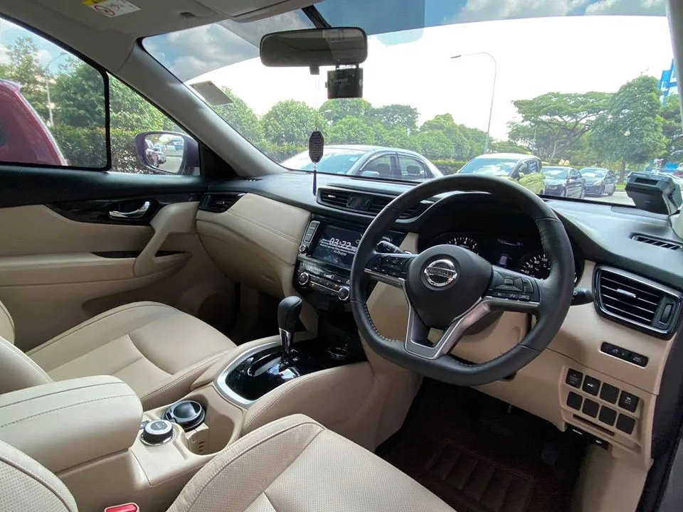 Nissan X-Trail beige interior and steering wheel seen through tinted glass at Infratint Singapore