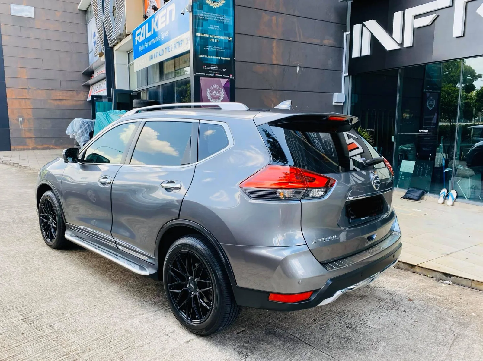 Grey Nissan X-Trail rear three-quarter view with tinted windows at Infratint Singapore