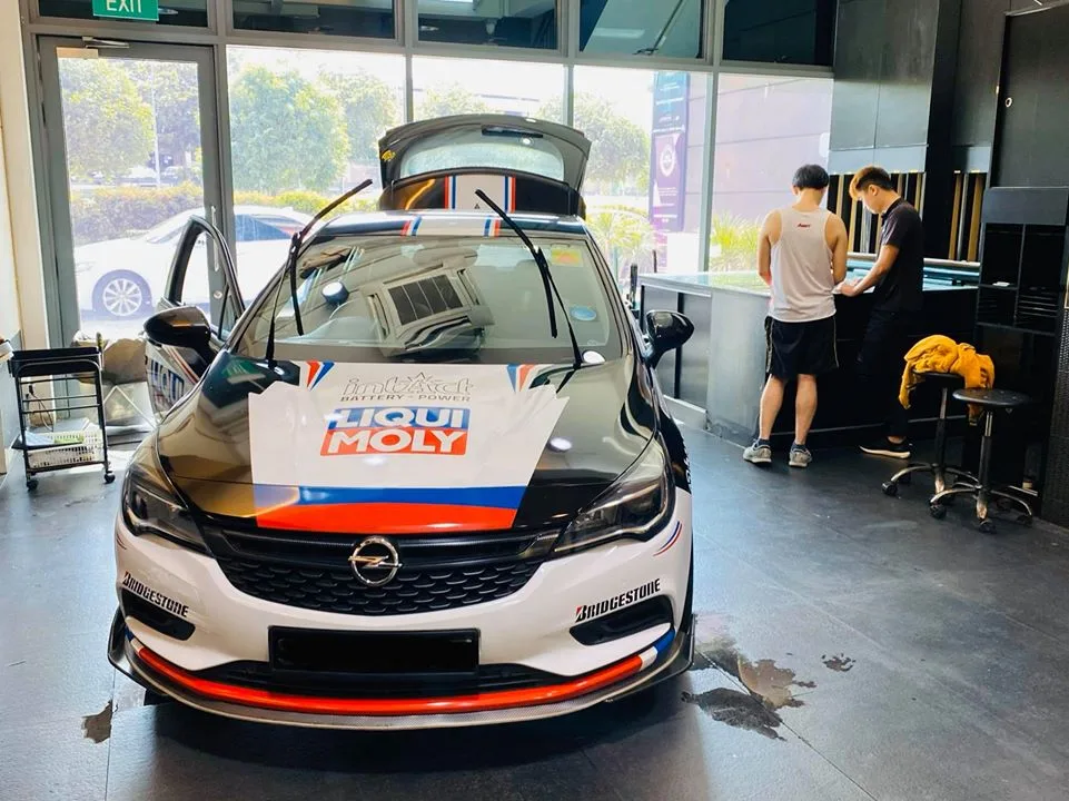 Liqui Moly liveried Opel Astra hatchback with bonnet and tailgate open at Infratint Singapore