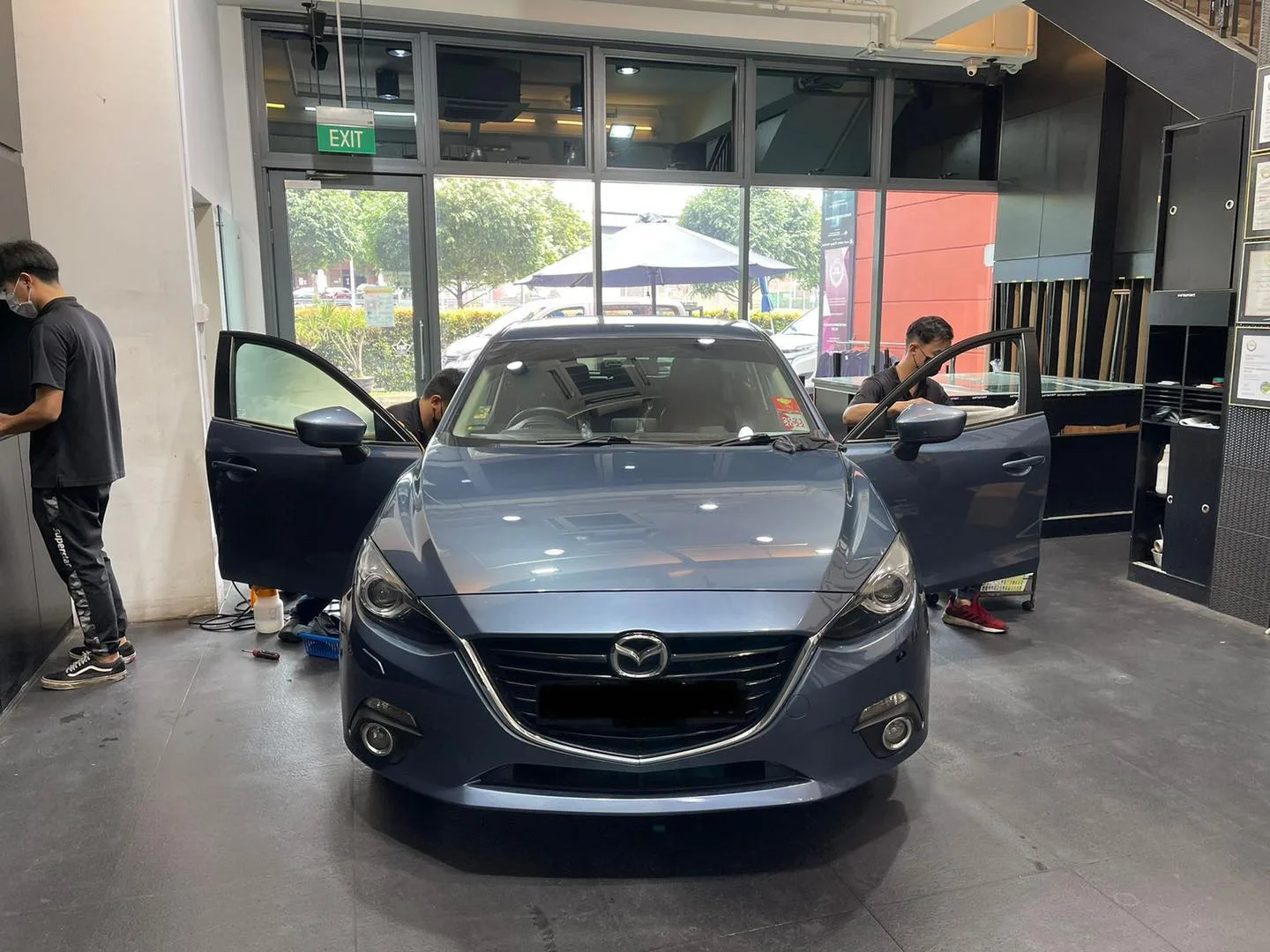 Blue-grey Mazda 3 having window film fitted at Infratint Singapore