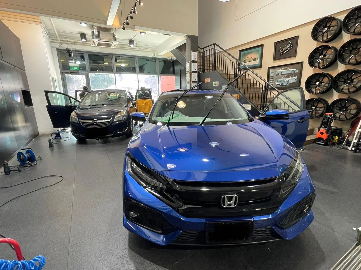 Blue Honda Civic and Opel Meriva at Infratint Singapore for window film