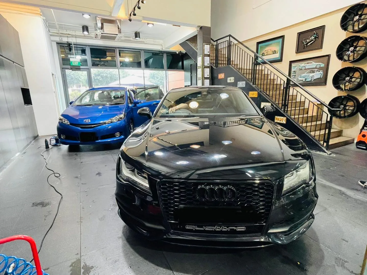 Black Audi quattro and blue Toyota hatch inside Infratint Singapore for window film