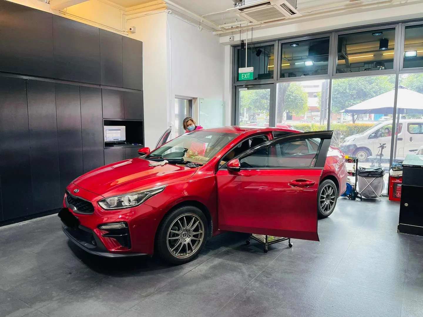 Red Kia sedan being tinted at Infratint Singapore
