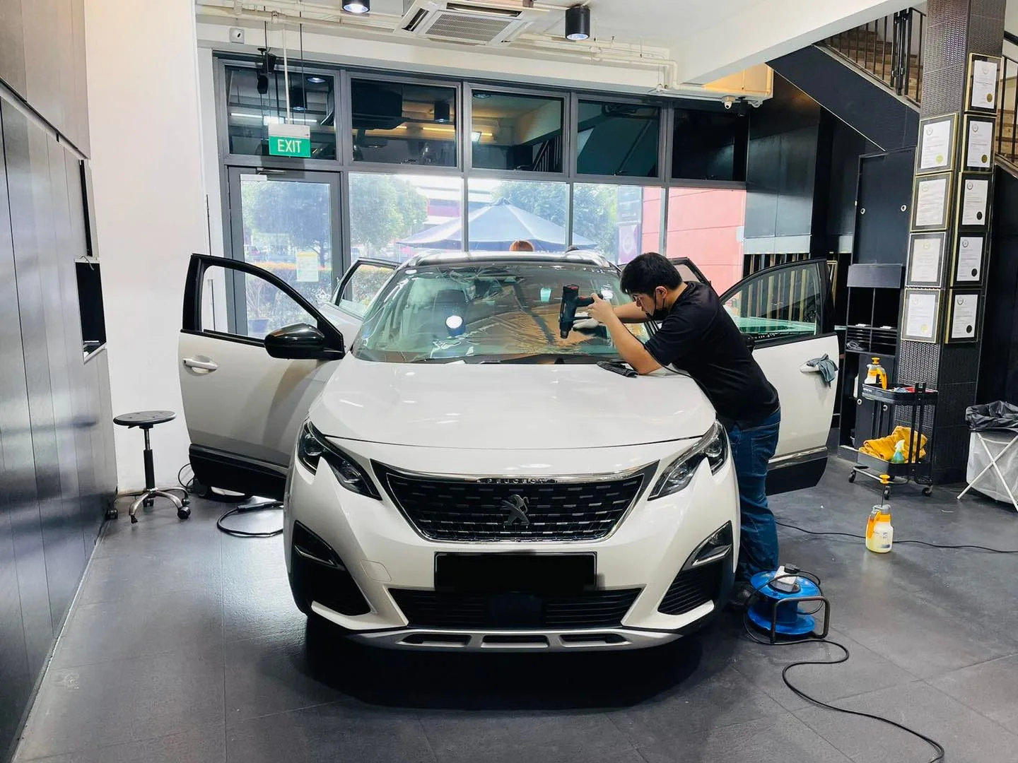White Peugeot SUV having its windscreen tinted at Infratint Singapore