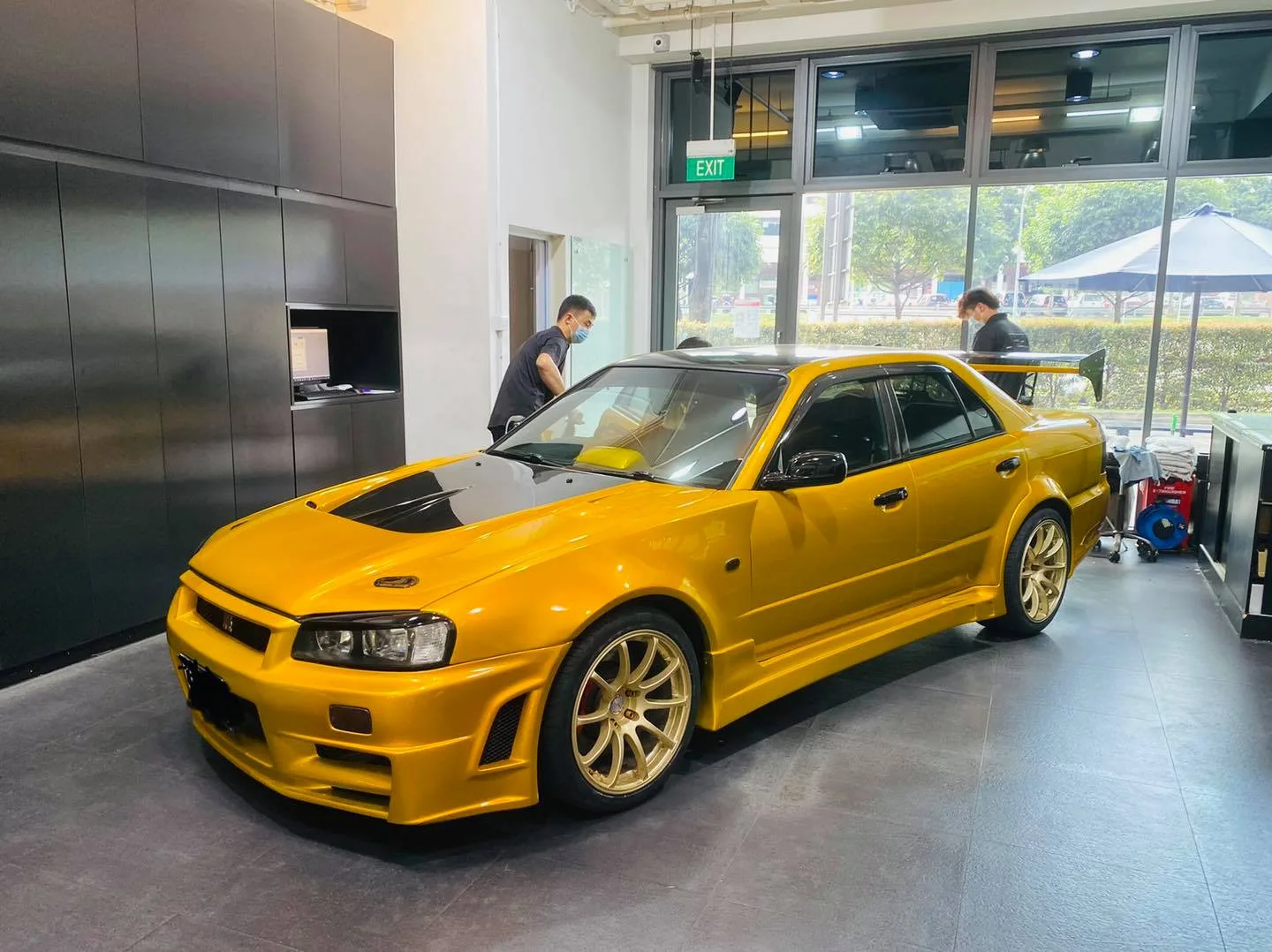 Yellow Nissan Skyline GT-R with gold wheels during window tinting at Infratint Singapore