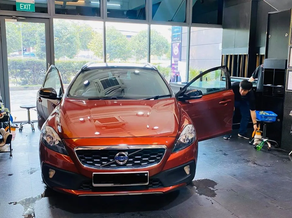 Orange Volvo V40 front grille with technician at Infratint Singapore