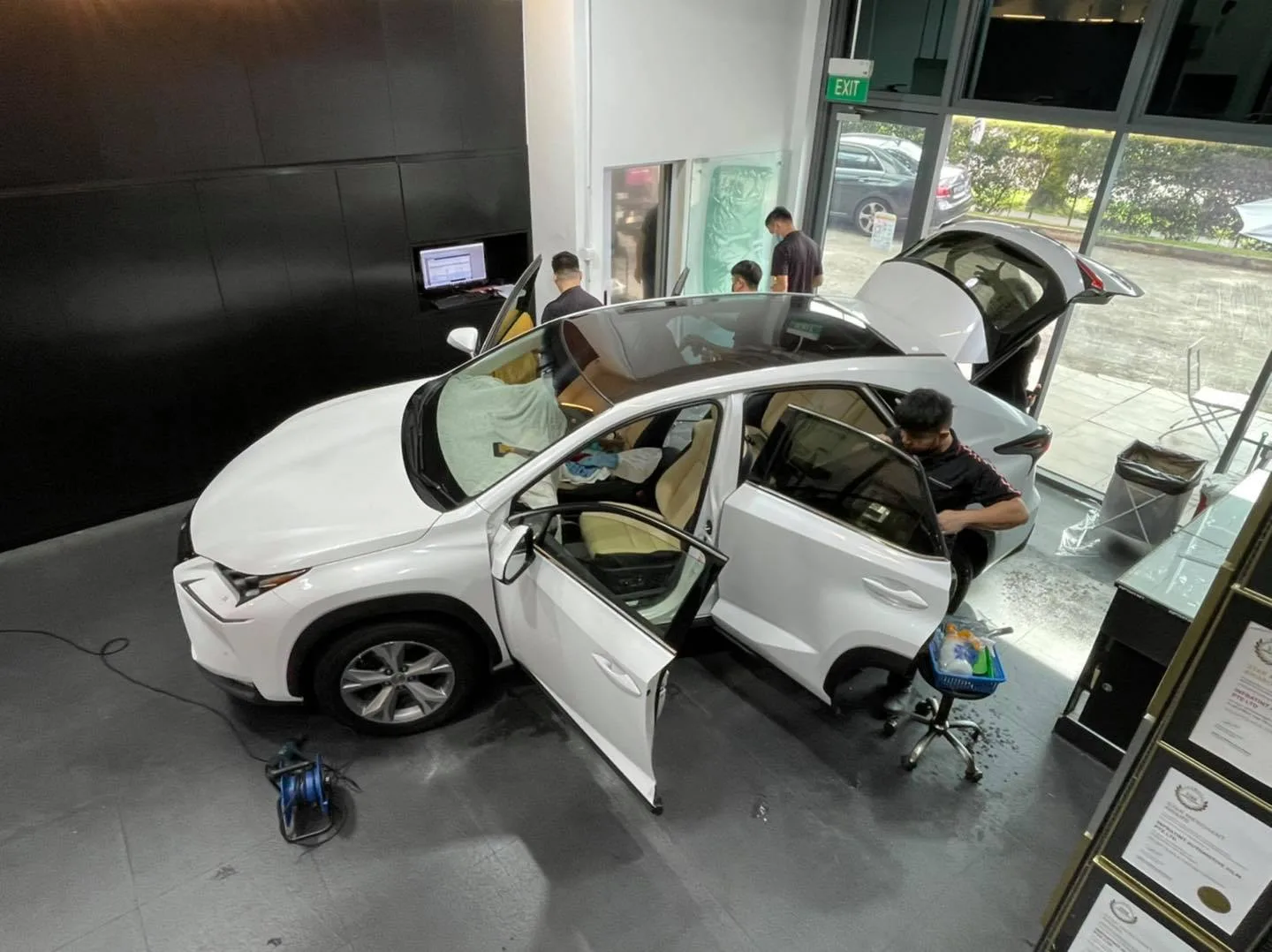 Overhead view of a white Lexus NX being tinted at Infratint Singapore