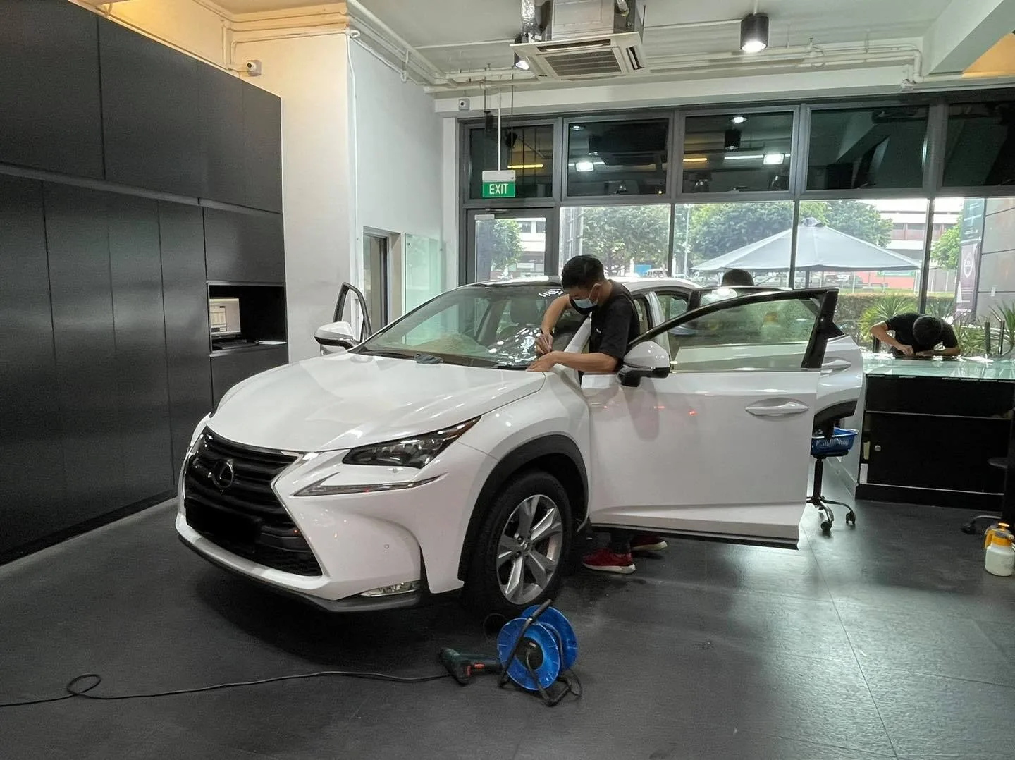 White Lexus NX side view during window film install at Infratint Singapore