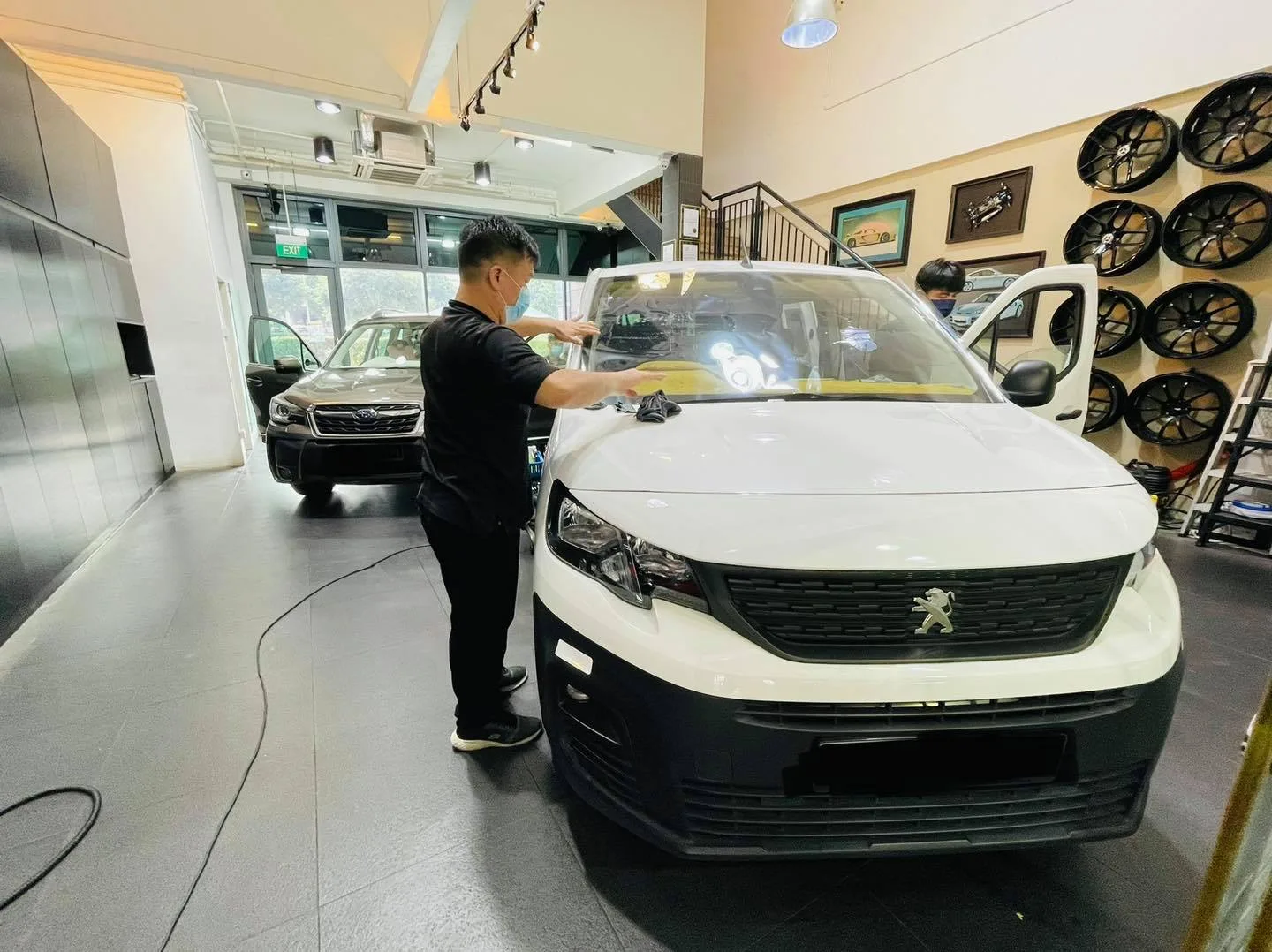White Peugeot Partner van being prepped for window film at Infratint Singapore