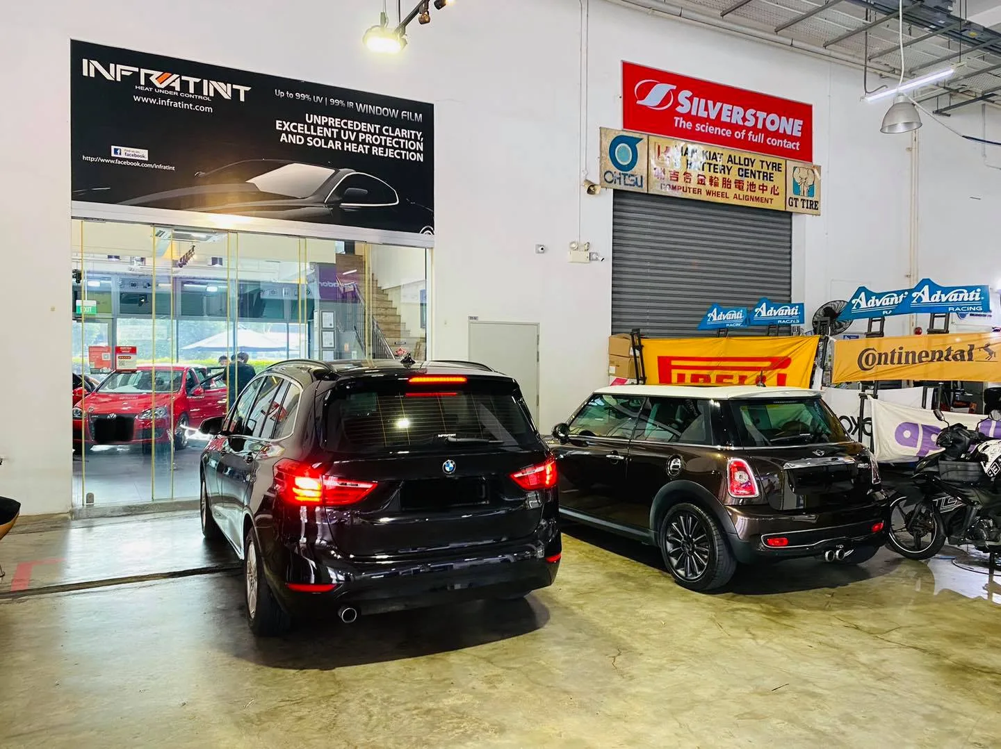 Black BMW wagon and black Mini under the Infratint Singapore banner for window tinting