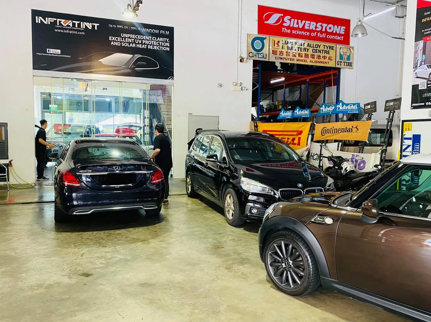 Black Mercedes-Benz C-Class, BMW MPV and brown Mini parked at Infratint Singapore