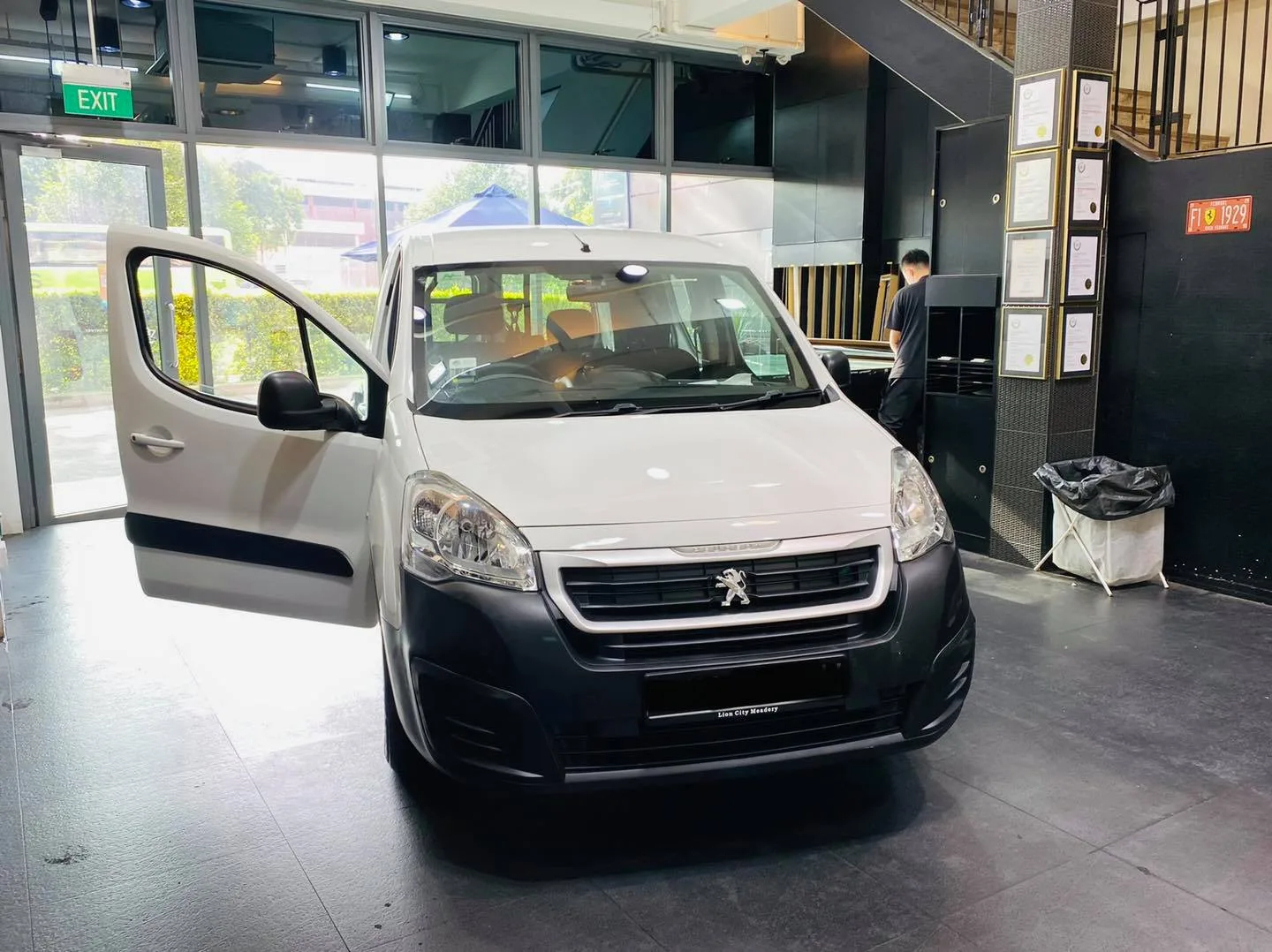 White Peugeot Partner van with door open at Infratint Singapore for window film