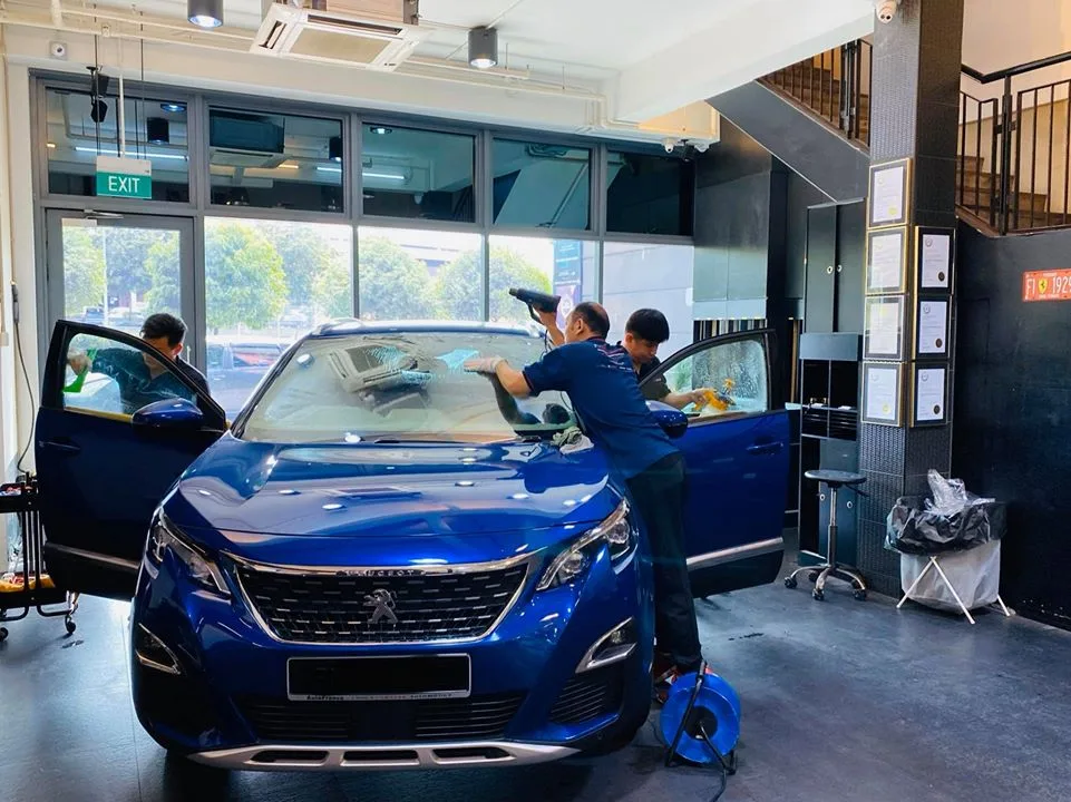 Blue Peugeot SUV having its windscreen film fitted at Infratint Singapore