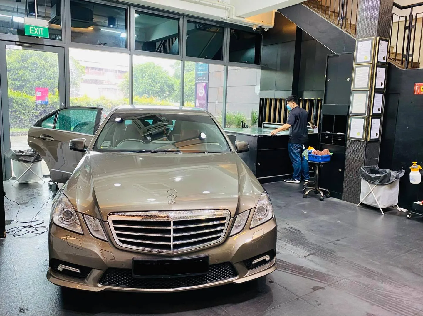 Front view of a bronze Mercedes-Benz E-Class with door open during tinting at Infratint Singapore