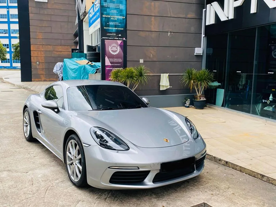 Silver Porsche 718 Cayman front three-quarter view outside Infratint Singapore
