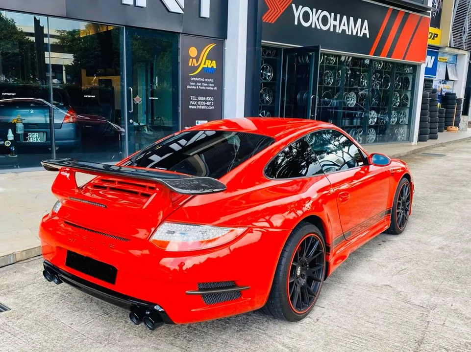 Rear view of a red Porsche 911 with spoiler at Infratint Singapore