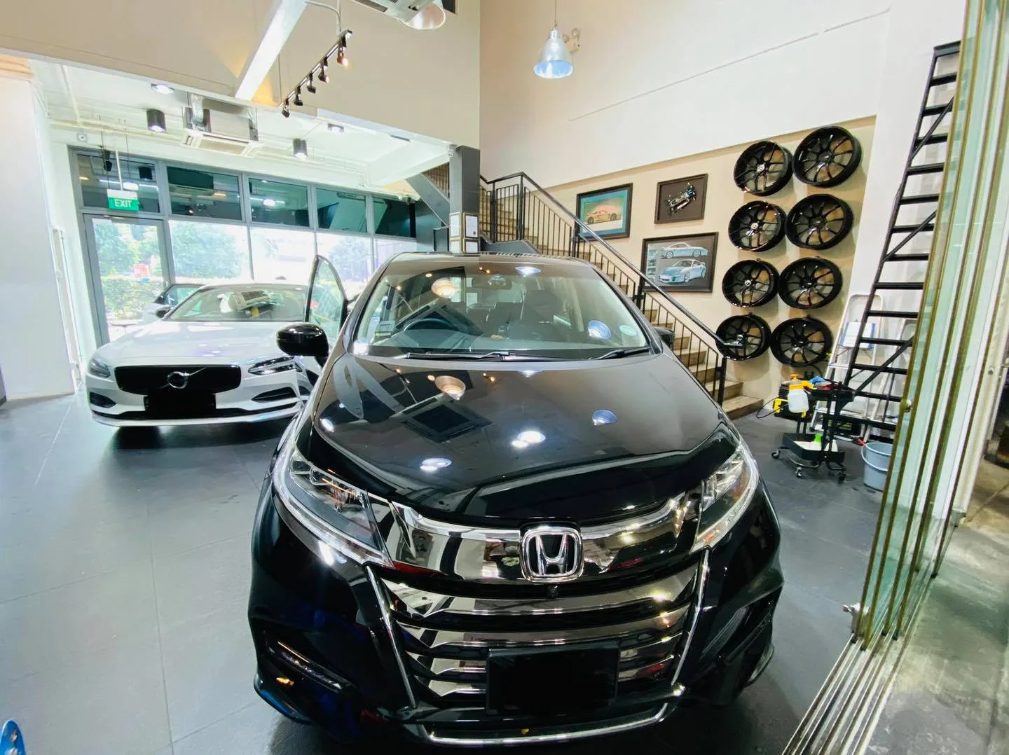 Black Honda Odyssey and white Volvo at Infratint Singapore for window film