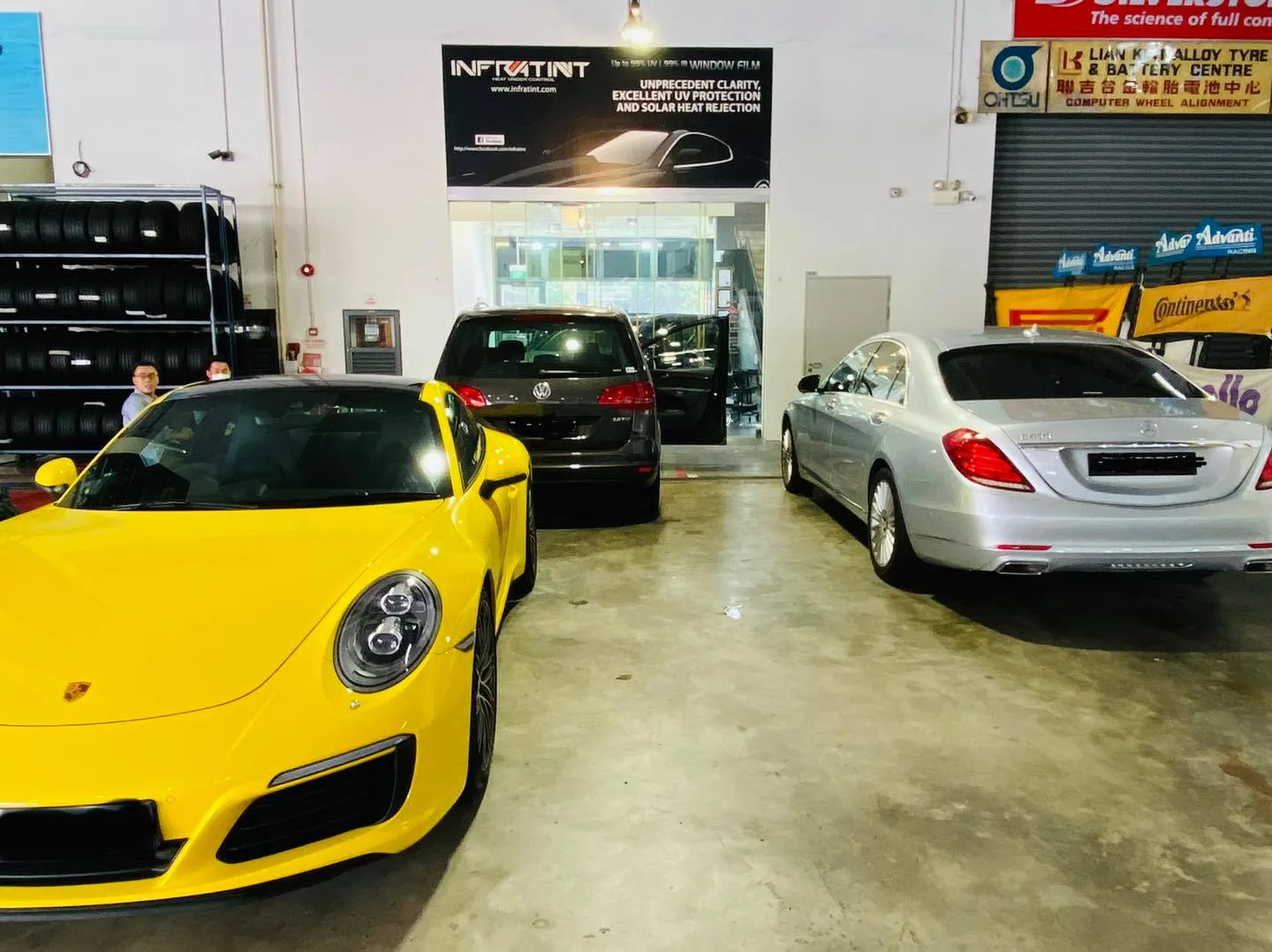 Yellow Porsche 911 and silver Mercedes-Benz sedan at Infratint Singapore