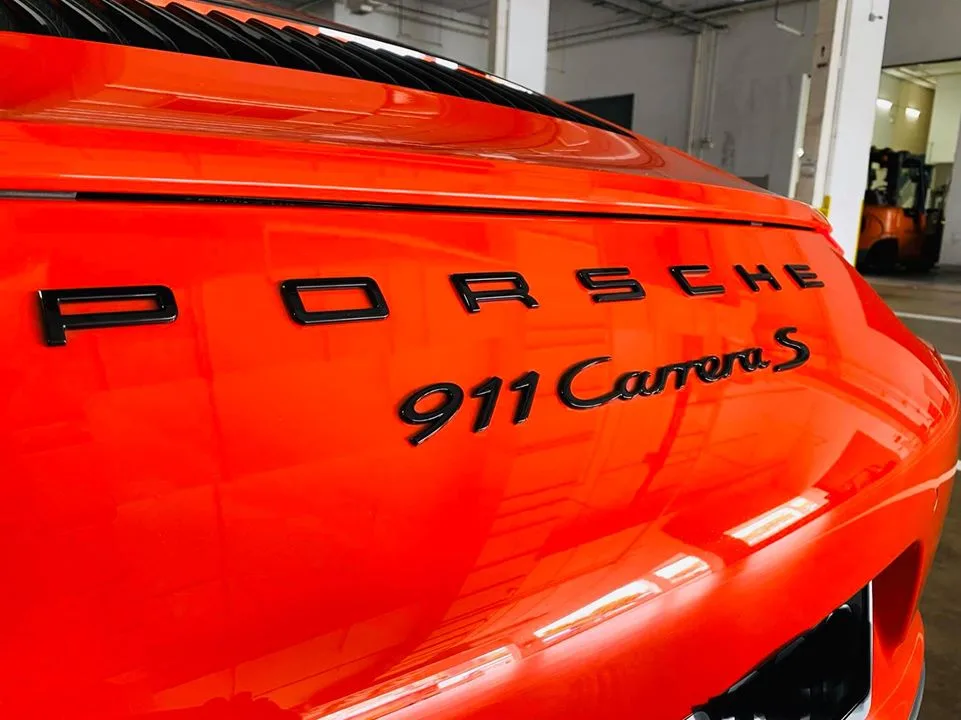 Close-up of the Porsche 911 Carrera S rear badge at Infratint Singapore