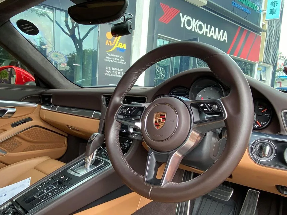 Tan and brown leather Porsche 911 interior with sports steering wheel at Infratint Singapore