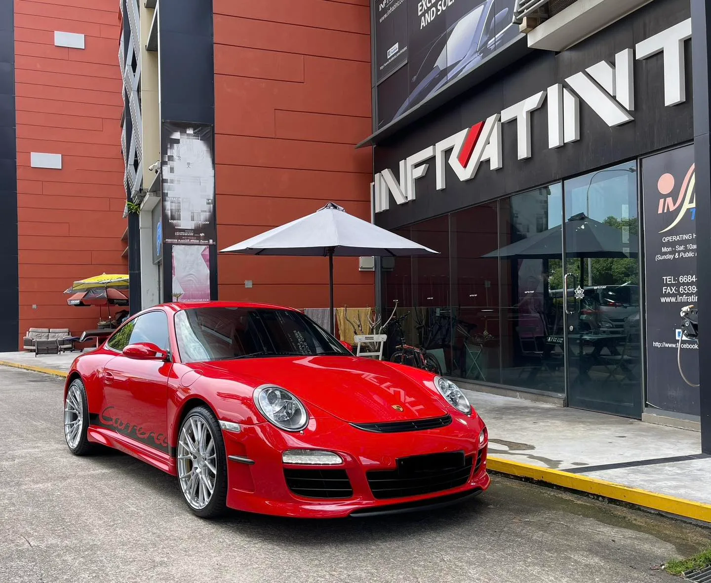 Red Porsche 911 front three-quarter view outside Infratint Singapore