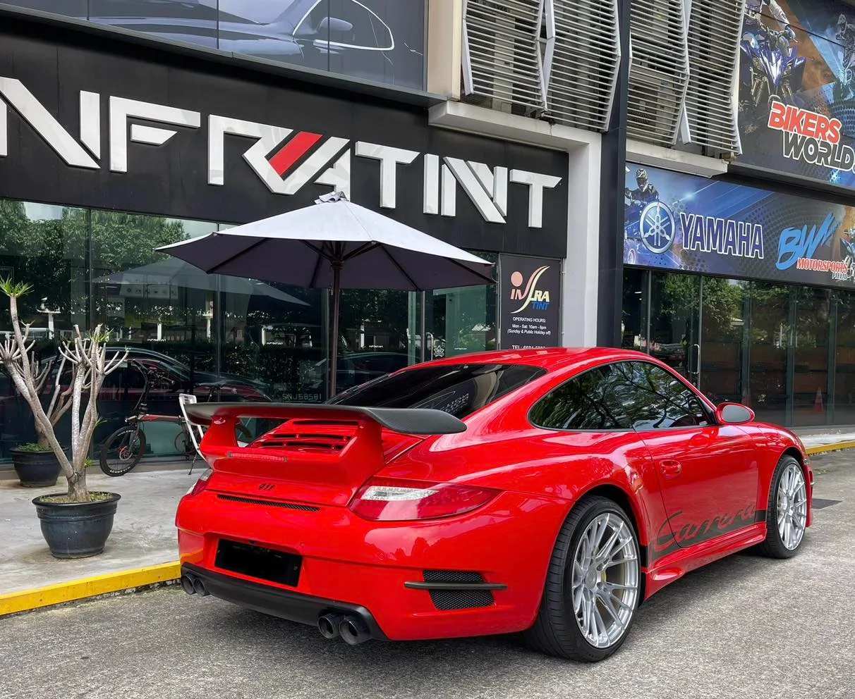 Red Porsche 911 side profile outside Infratint Singapore
