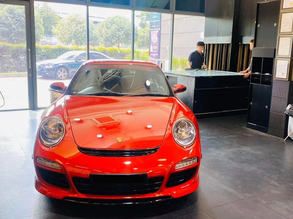 Red Porsche 911 parked front-on in the showroom at Infratint Singapore