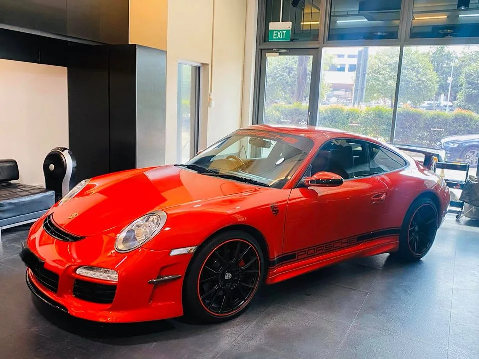 Red Porsche 911 with side decals and tinted glass at Infratint Singapore