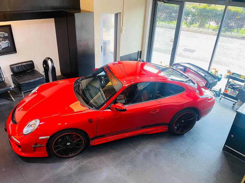 Red Porsche 911 from above with black wheels at Infratint Singapore
