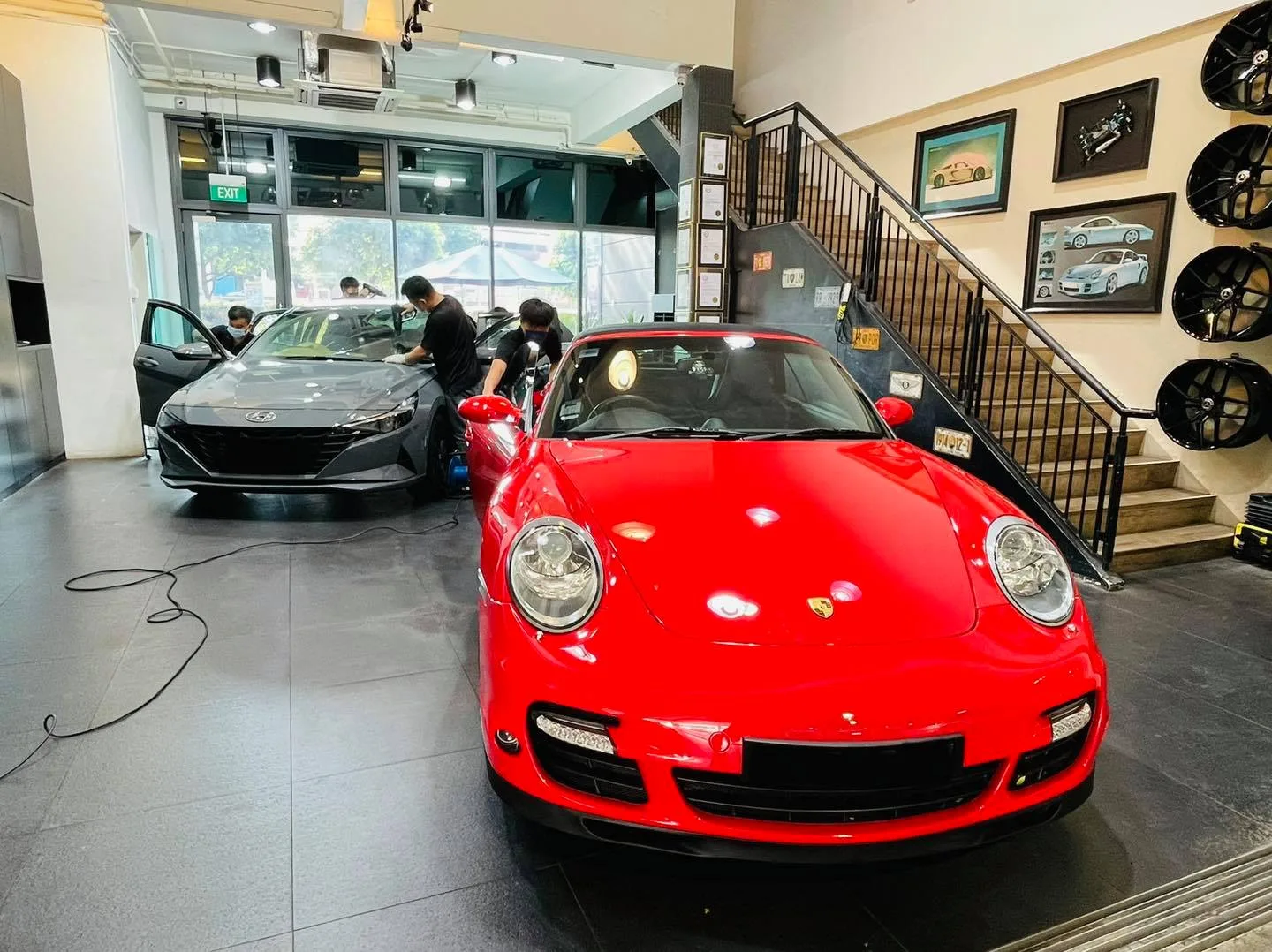 Red Porsche 911 Turbo and grey Hyundai sedan being tinted at Infratint Singapore