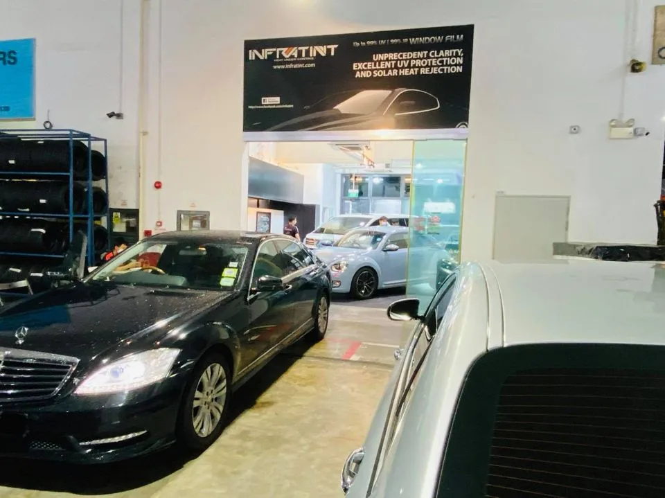 Black Mercedes-Benz S-Class and silver Volkswagen Beetle at Infratint Singapore window film bay