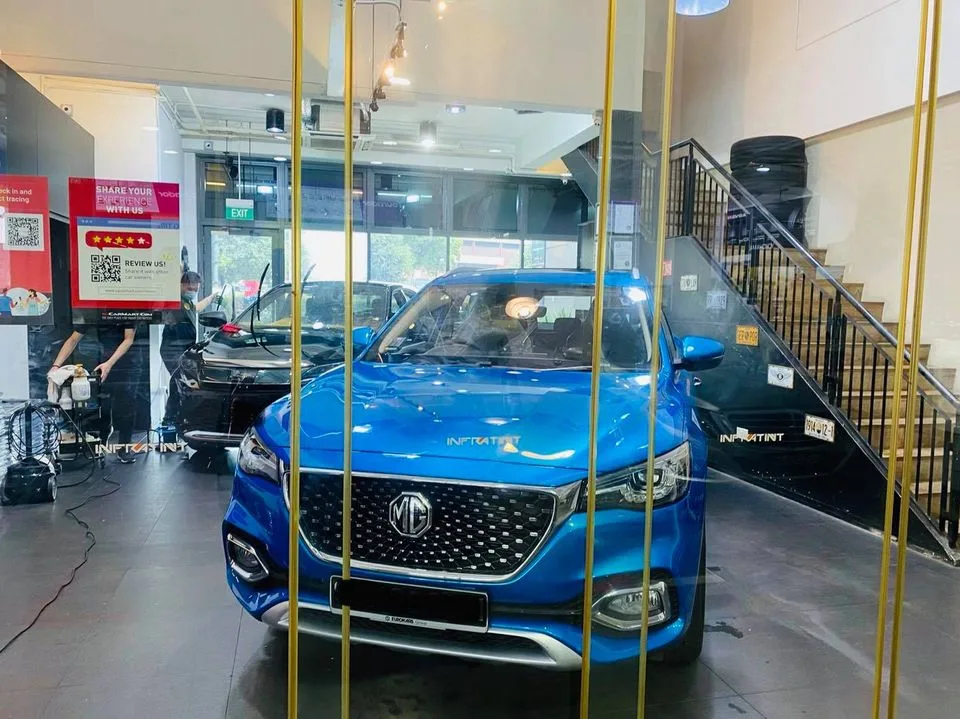 Blue MG HS SUV being prepared for window tinting at Infratint Singapore
