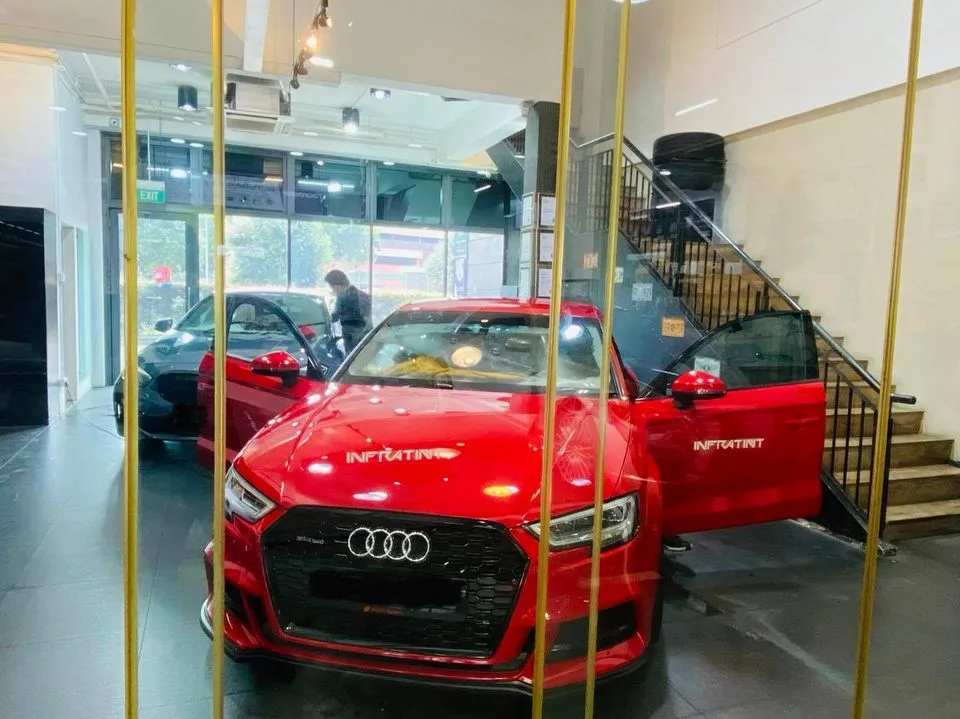 Red Audi A3 with doors open during window tinting at Infratint Singapore
