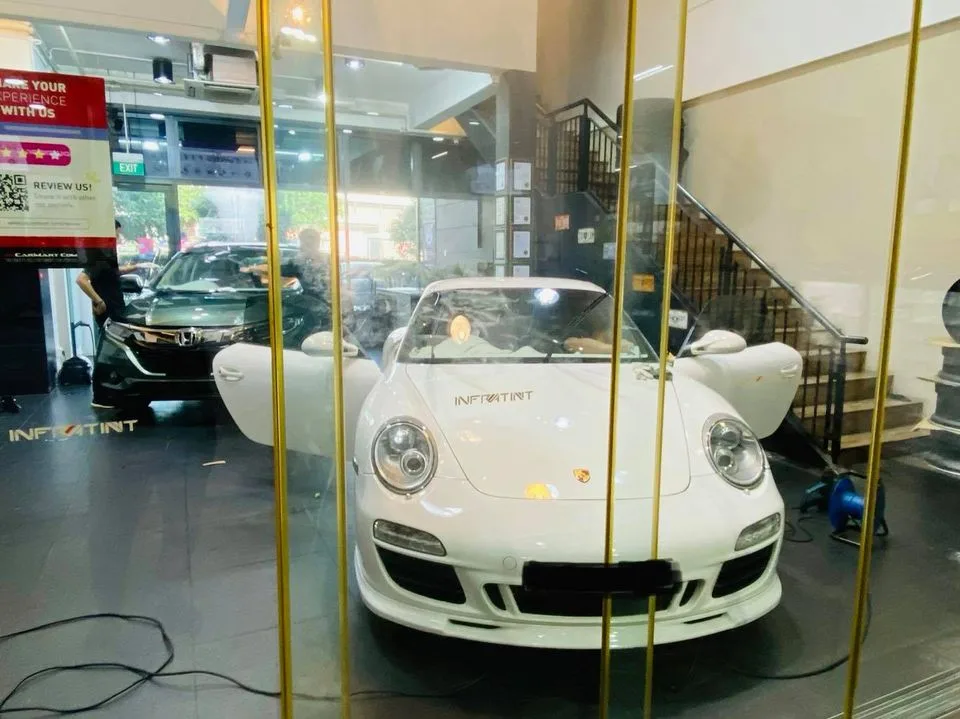 White Porsche 911 Carrera and green Honda Vezel at Infratint Singapore for window film