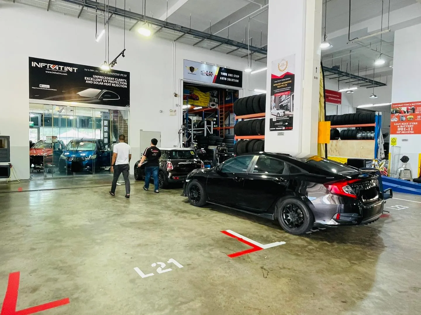 Dark sedan parked in the Infratint Singapore install bay awaiting window film
