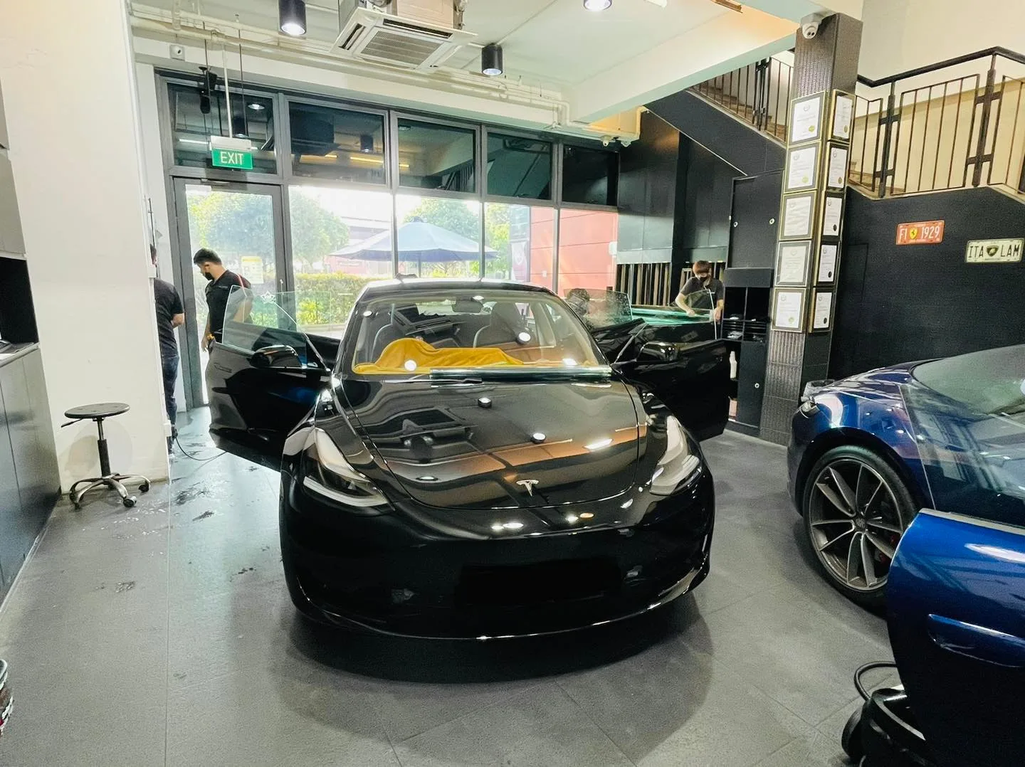 Black Tesla Model 3 in the Infratint Singapore showroom for window tinting