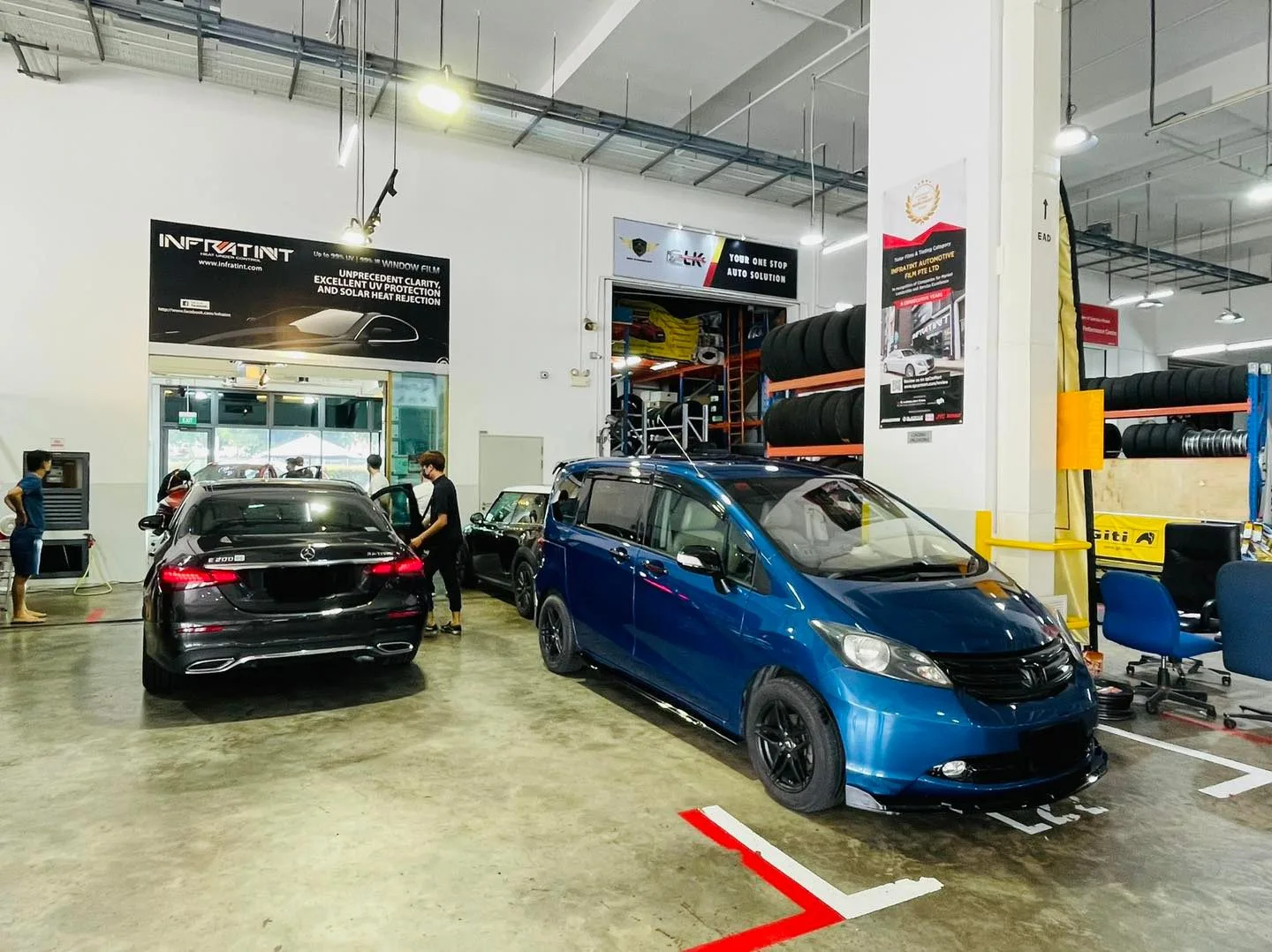 Blue Honda Freed and a dark Honda wagon at Infratint Singapore for window tinting
