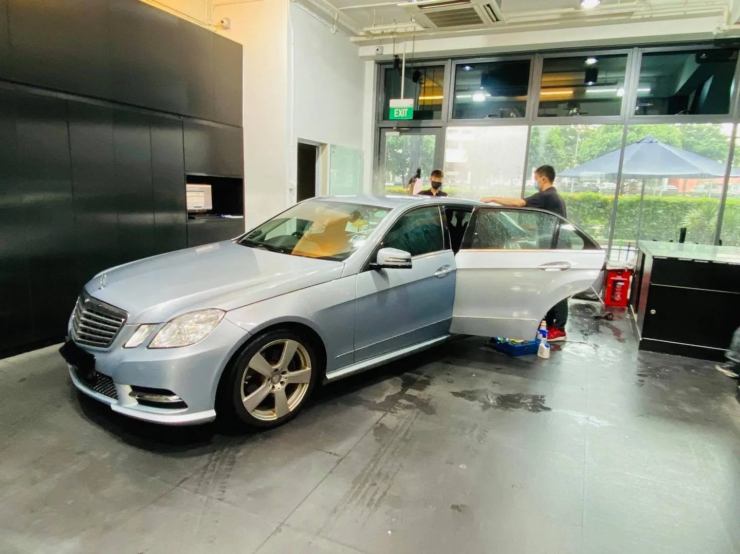 Light blue Mercedes-Benz E-Class side view during window film install at Infratint Singapore