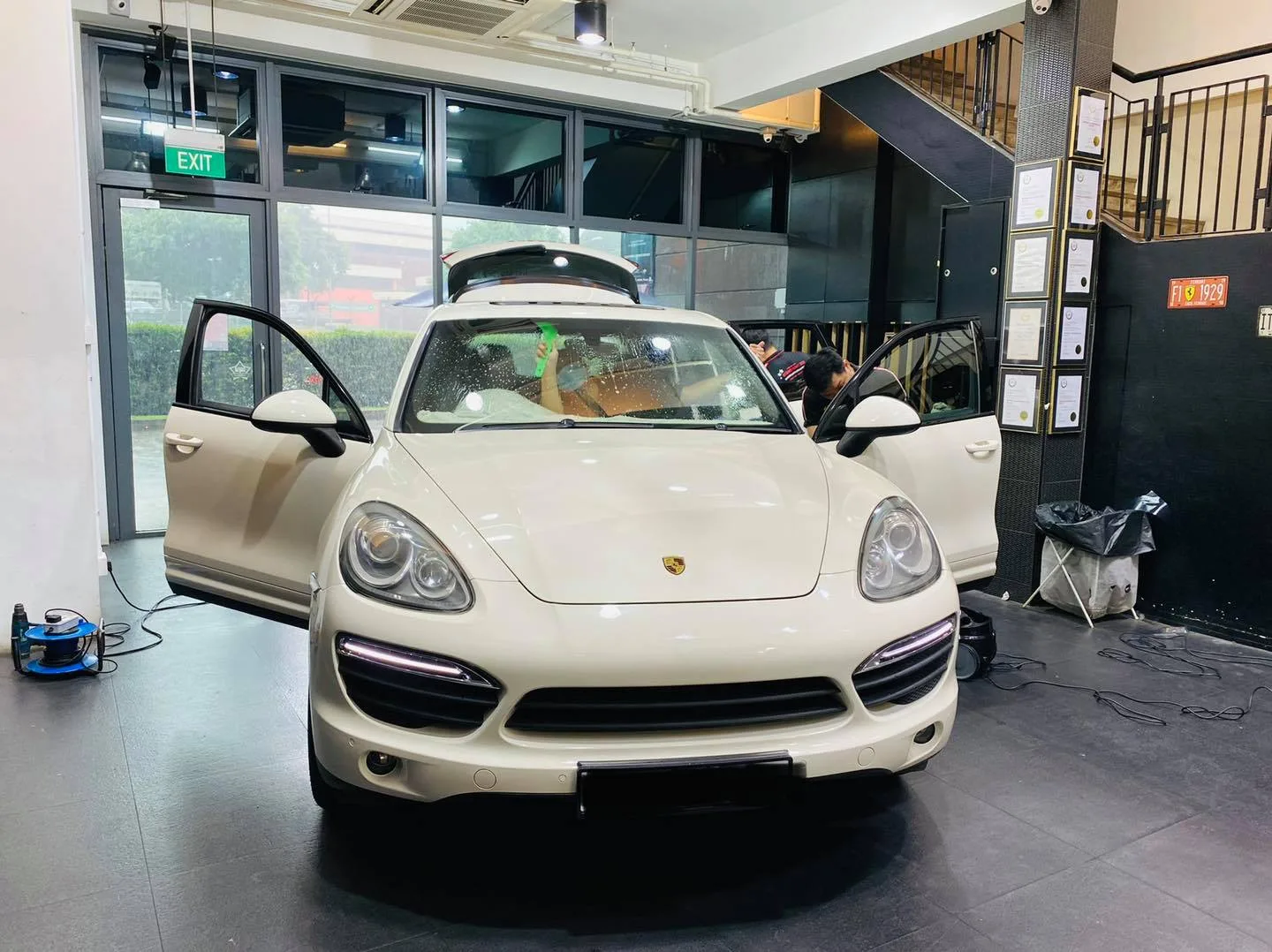 White Porsche Cayenne SUV with doors open for window tinting at Infratint Singapore