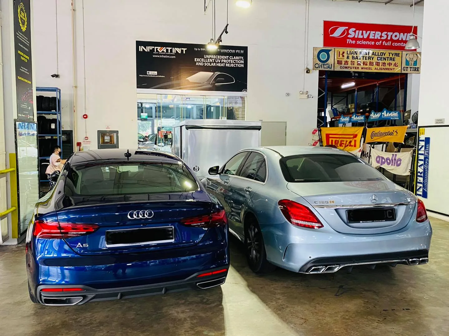 Blue Audi A5 and silver Mercedes-Benz C-Class at Infratint Singapore install bay