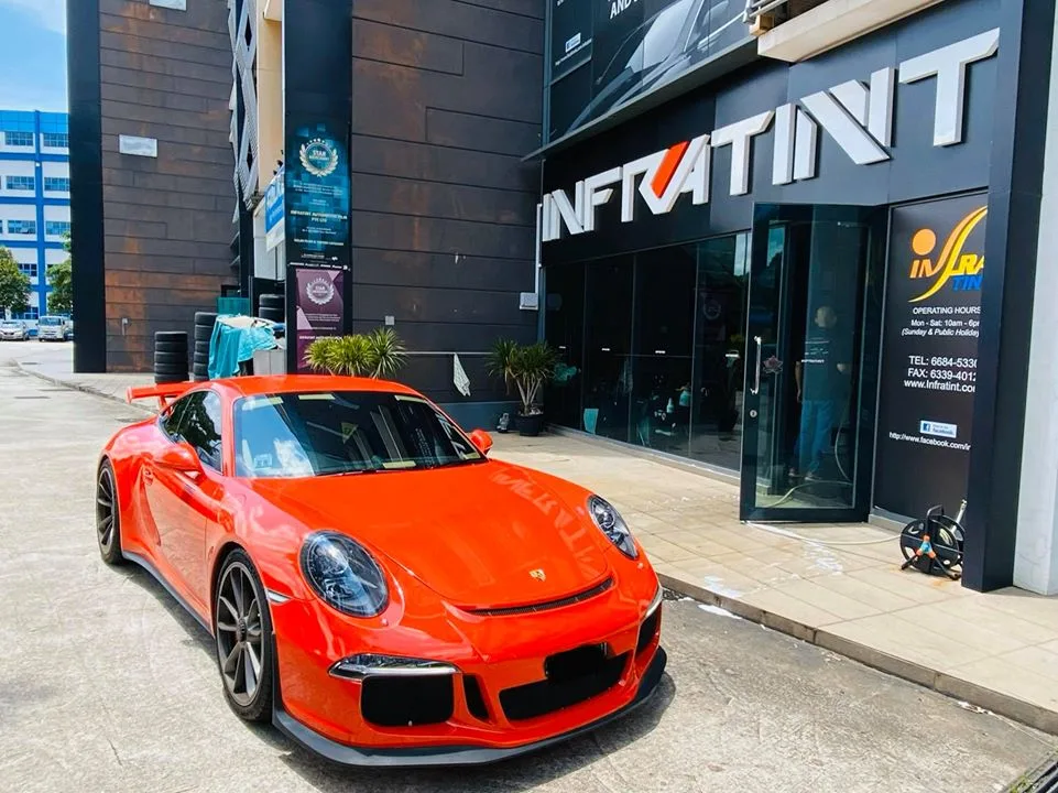 Orange Porsche 911 GT3 parked outside Infratint Singapore