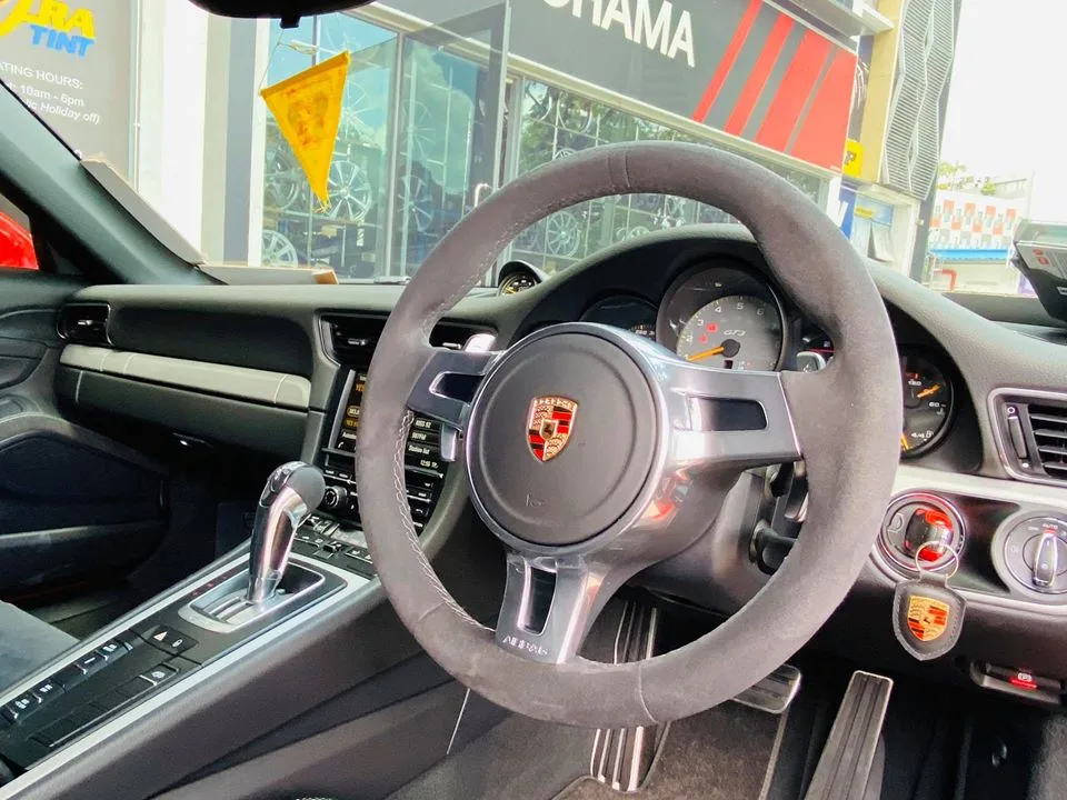 Alcantara steering wheel and dashboard of a Porsche 911 GT3 at Infratint Singapore