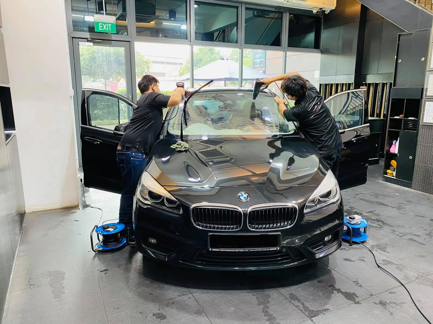 Black BMW 2 Series tourer during window film install at Infratint Singapore